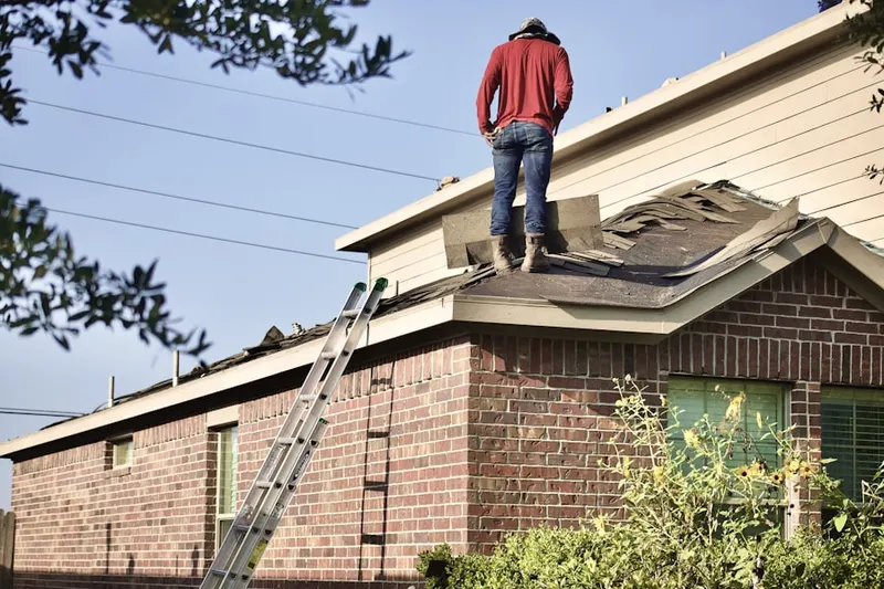 Professional roofer working on a residential roof in Cameron Villa Farms